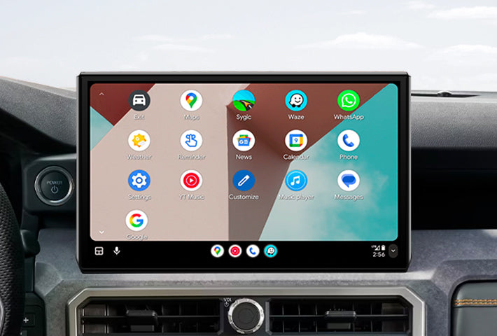 In-car view showing the Android Auto interface on a Toyota Sienna head unit, featuring a multi-pane layout with navigation and communication apps, compatible with both wired and wireless connections.