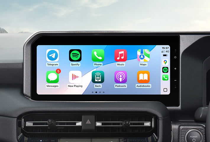 In-car view showing the wireless Apple CarPlay interface on a Toyota Sienna head unit touchscreen, displaying apps like Phone, Messages, Maps, and Spotify for easy access while driving.