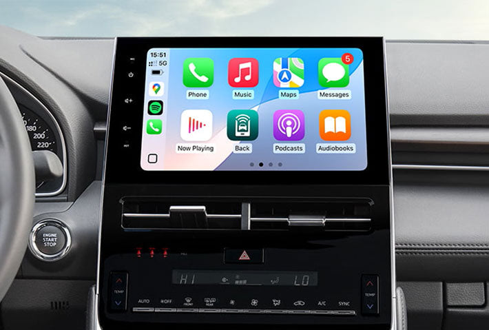 In-car view showing the wireless Apple CarPlay interface on a Toyota Sienna head unit touchscreen, displaying apps like Phone, Messages, Maps, and Spotify for easy access while driving.