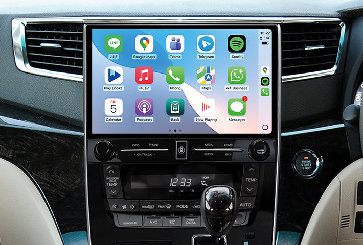 In-car view showing the wireless Apple CarPlay interface on a Toyota Sienna head unit touchscreen, displaying apps like Phone, Messages, Maps, and Spotify for easy access while driving.